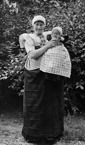 128056 Afbeelding van een vrouw met kind in Spakenburger klederdracht.